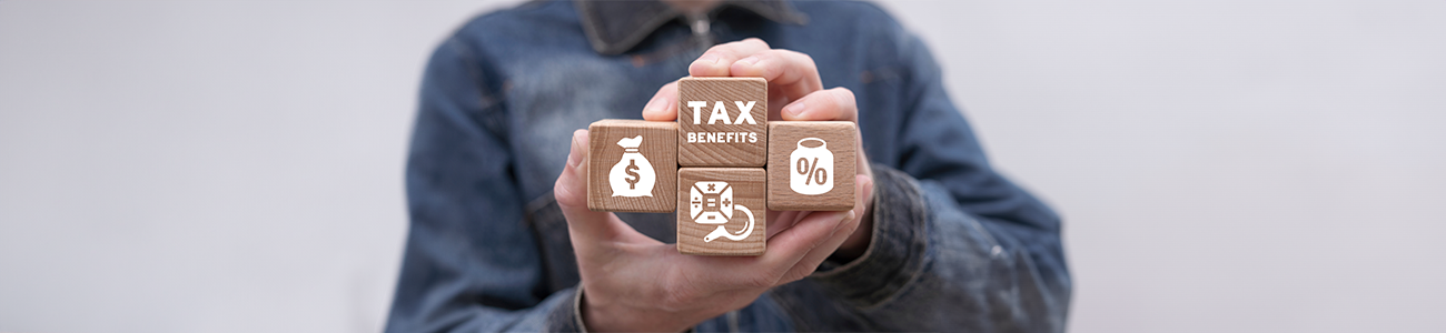 Representation of tax benefits with wooden blocks and symbols.